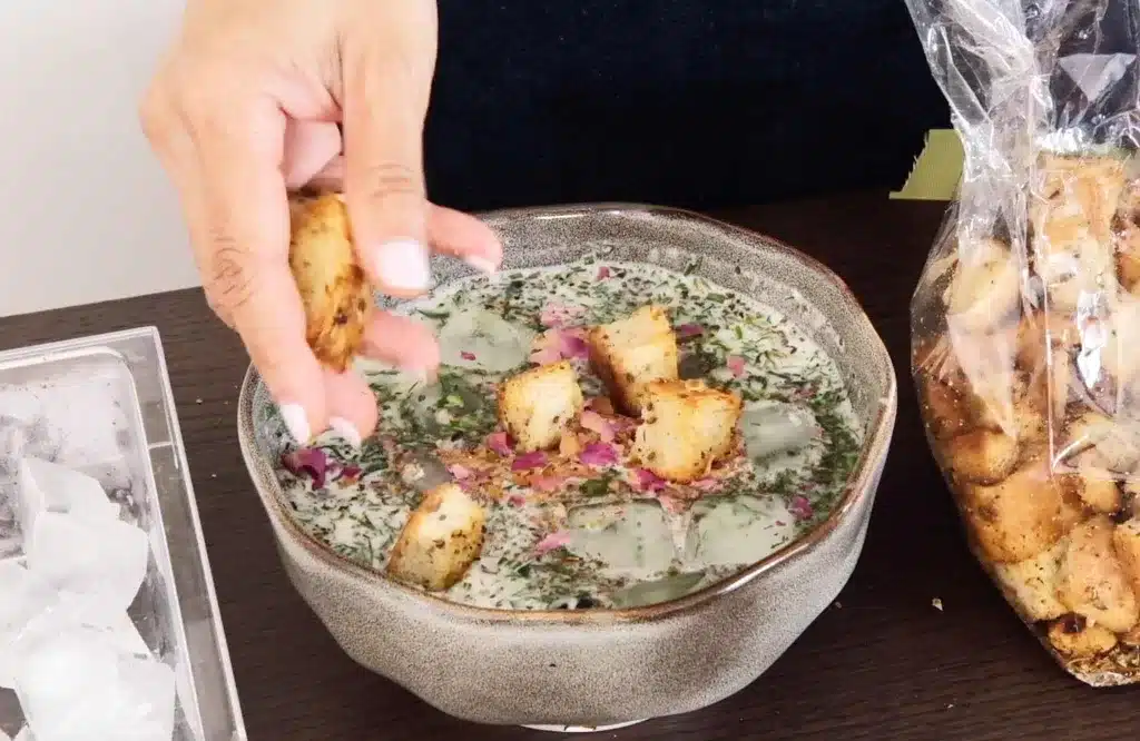 Adding bread to the cold yogurt soup