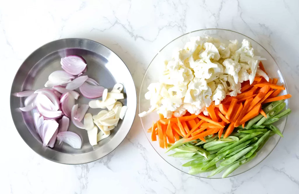 Onion, garlic, cauliflower, carrot, beans cut into smaller pieces