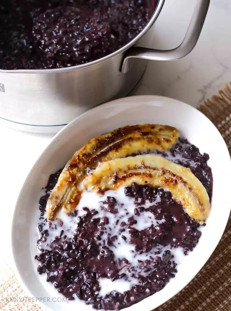 Black sticky rice dessert in a bowl with caramelized banana