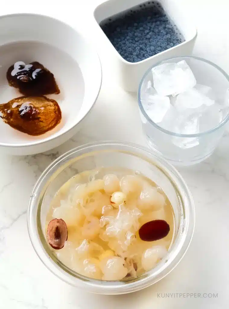 Cooked lai chi kang, ice cubes, blooming malva nuts and basil seeds in separate bowls