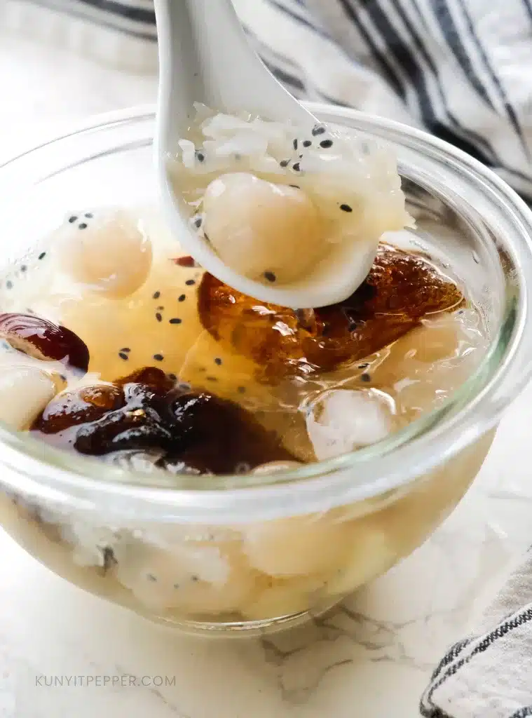 Scooping Lean Chee Kang with a spoon from the bowl