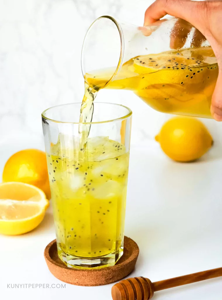 Pouring a jar of traditional Iranian basil seed drink with honey into a glass