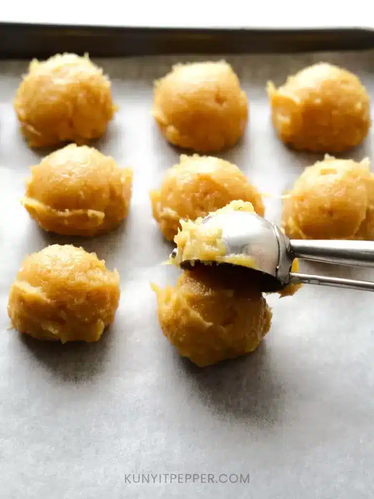 Scoop lemongrass ground chicken with ice cream scoop onto the tray line wit baking sheet