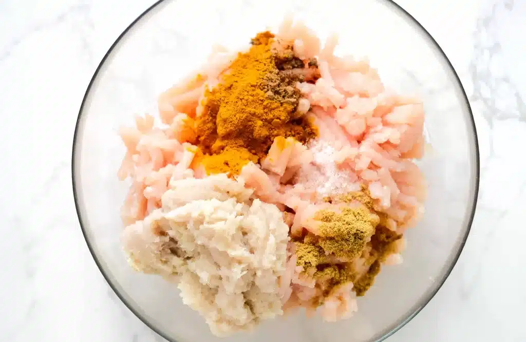 ground chicken meatballs ingredients in a bowl - before mixing