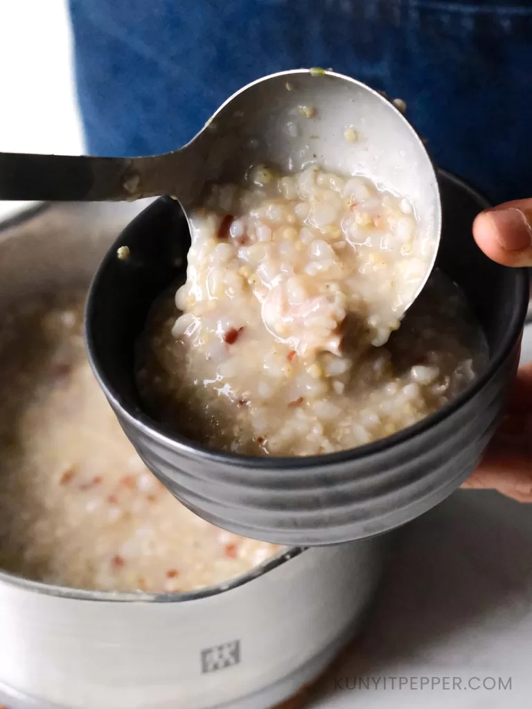 Scooping multigrain chicken rice porridge into a small bowl_2