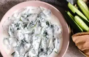 Persian Yogurt Spinach Dip (Borani-Esfenaj) Next to assorted veggies and bread.